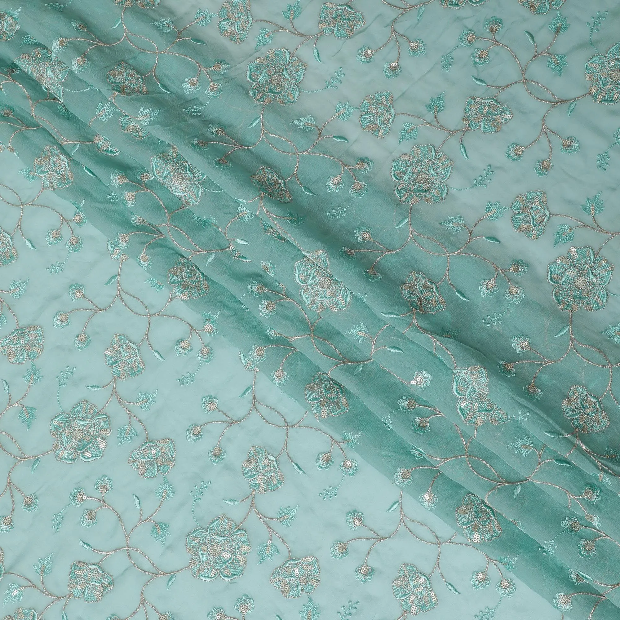 Light teal blue synthetic georgette fabric with same tone and gold embroidery in floral design-D15819