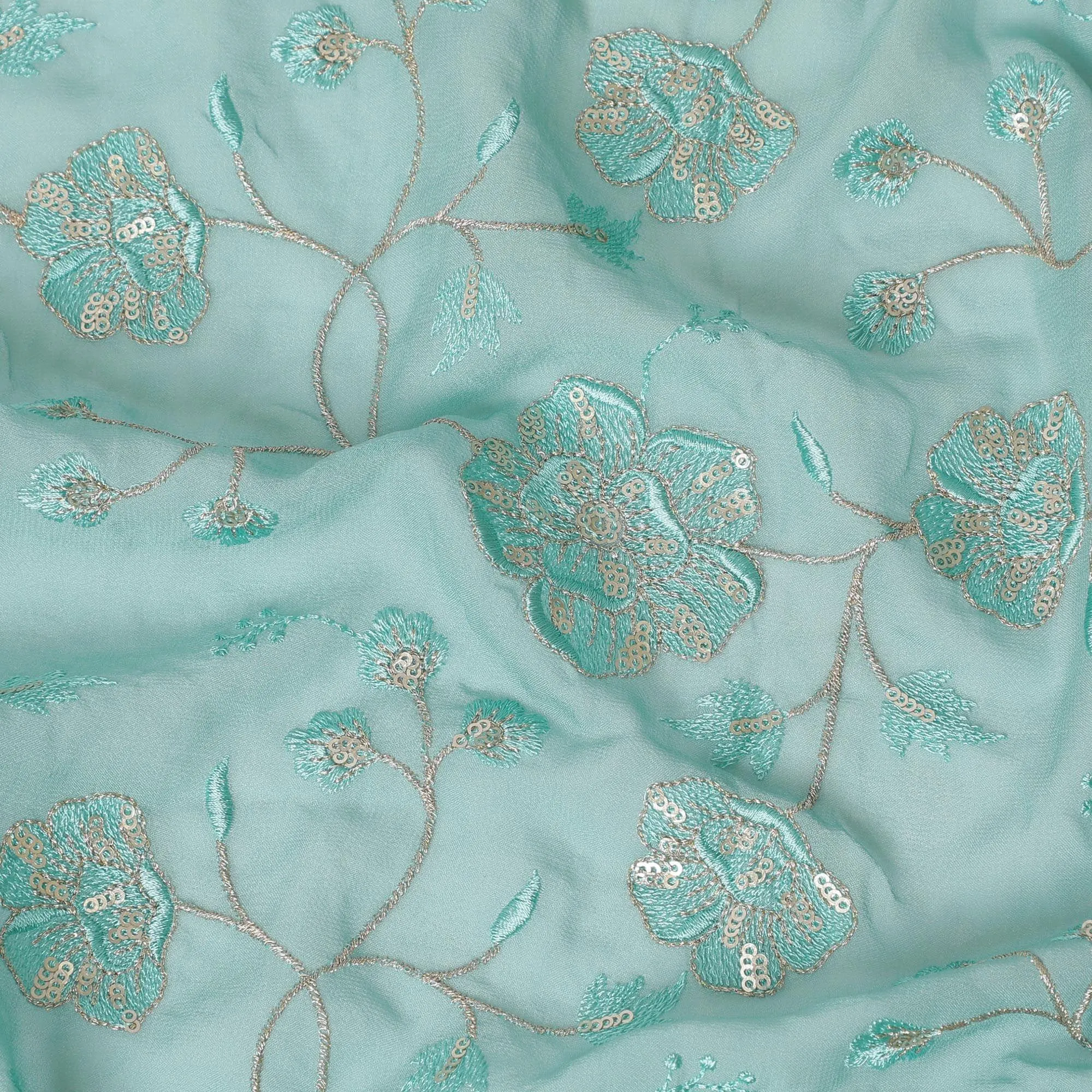 Light teal blue synthetic georgette fabric with same tone and gold embroidery in floral design-D15819